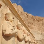 Egypt Royal Tours - Ancient statues against rocky backdrop.